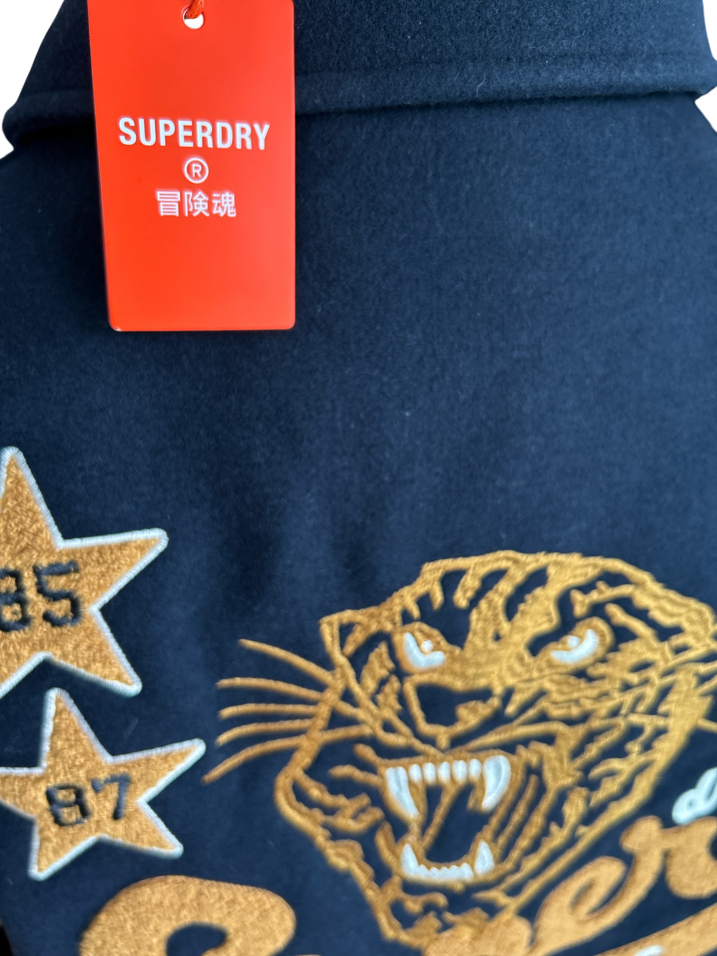 SUPERDRY WILD CATS NAVY COLLARED PATCHED BOMBER IN NAVY UK SIZE EXTRA LARGE.