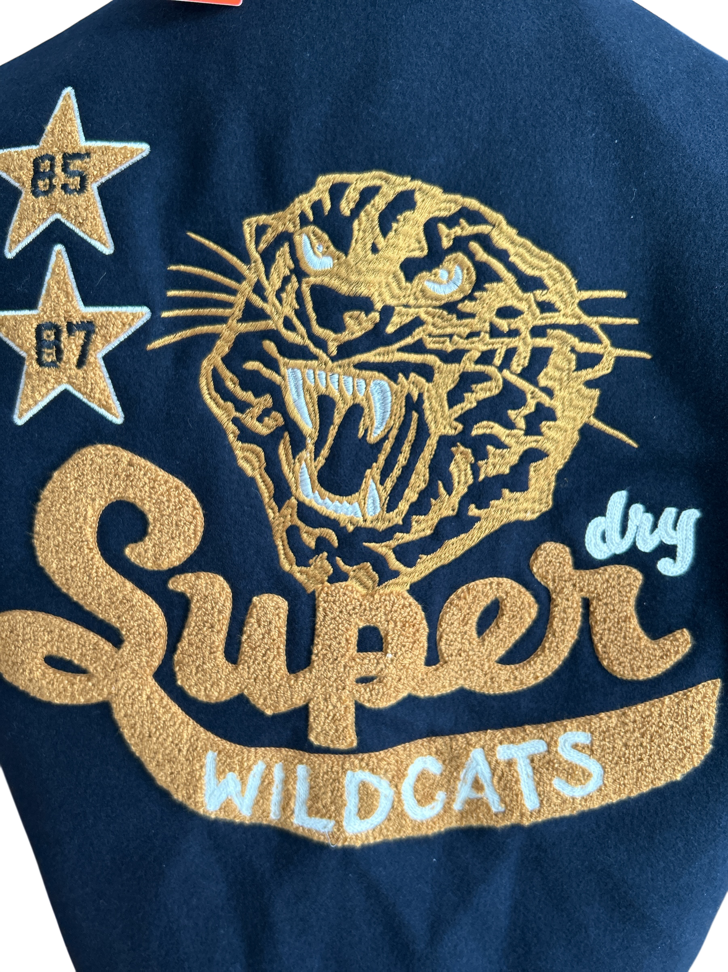 SUPERDRY WILD CATS NAVY COLLARED PATCHED BOMBER IN NAVY UK SIZE EXTRA LARGE.